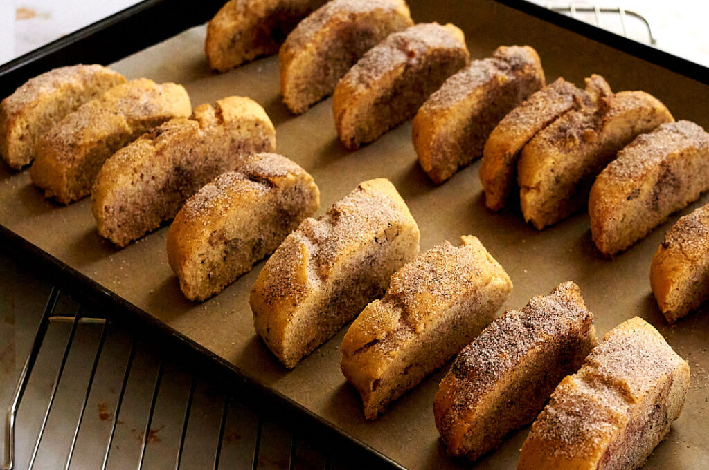 A tray lined with slices of baked mandel bread.